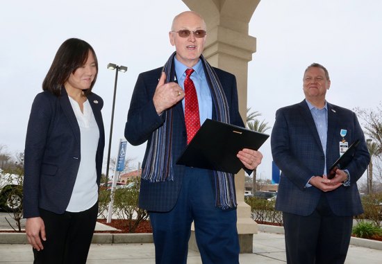 Retired General Jim Combs delivers rare Patriot Awards to Adventist Dr. Michael Boulton and Nurse Practitioner Dawn Huong-Schleif for their support of the military members who are employed at the hospital.